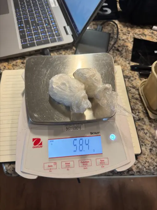 Photos released by the sheriff's office depict the seized items, including stacks of U.S. currency and packages of cocaine displayed on a digital scale. Credit: Volusia County Sheriff's Office 