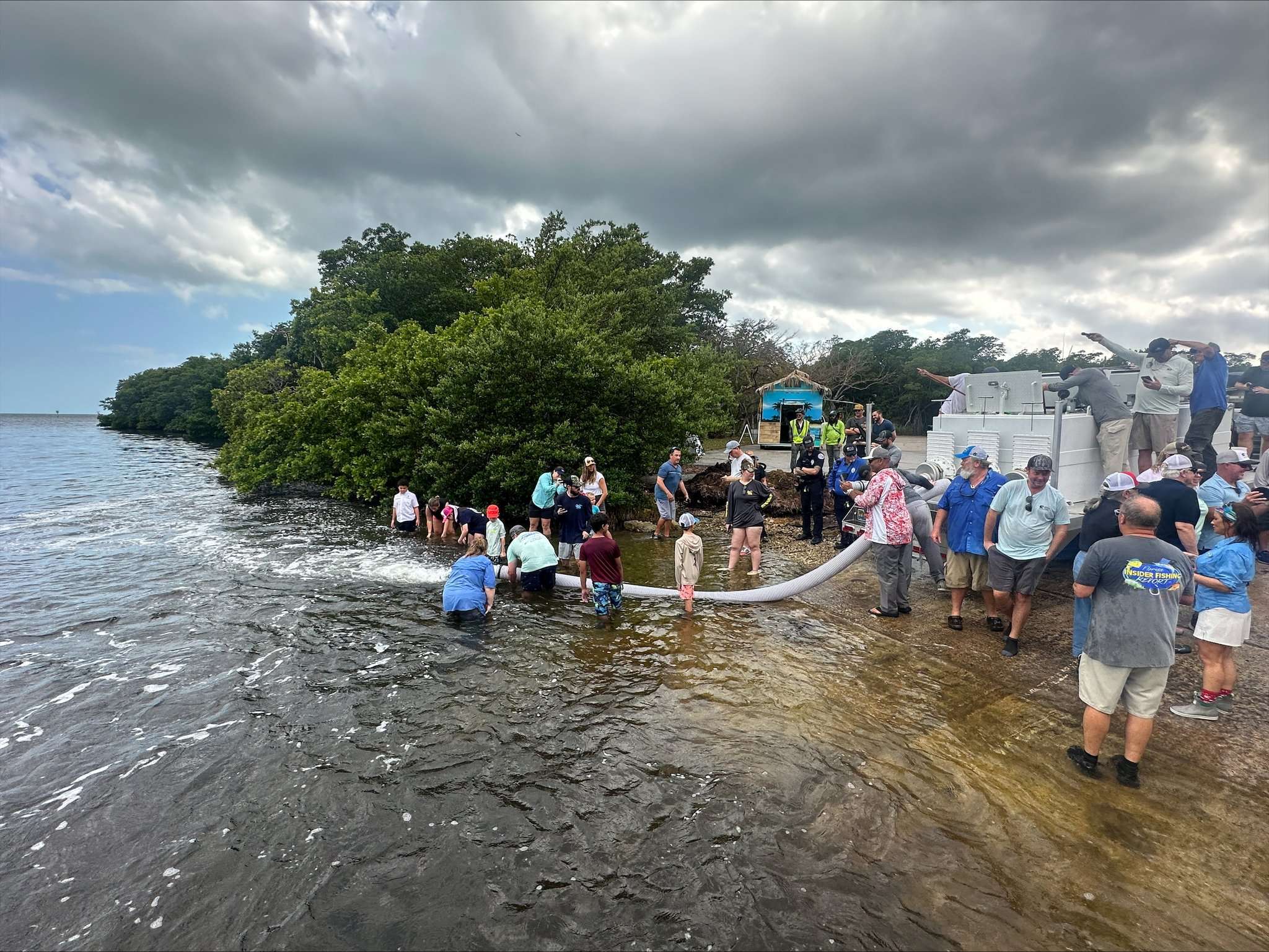 Landscape of FWC staff and partners releasing redfish into Biscayne Bay. Credit: Florida Fish and Wildlife Conservation Commission