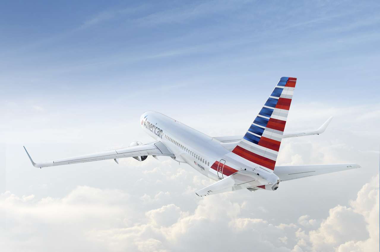 American airlines plane flying at high altitude.