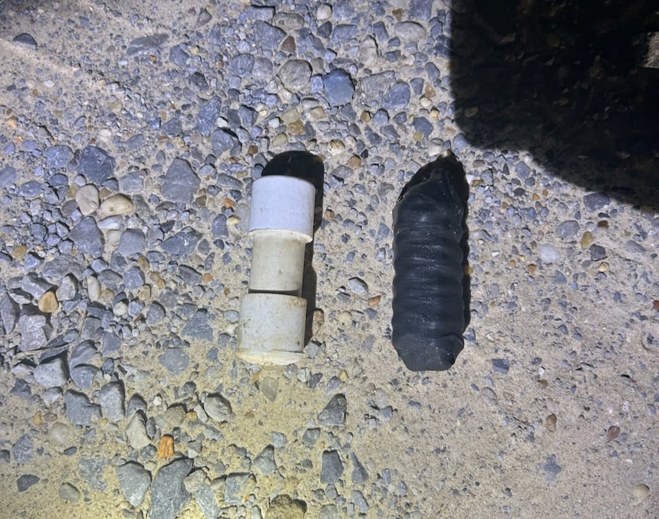 Two pipe bombs discovered during a traffic stop, one made of PVC with end caps and the other wrapped in black electrical tape,