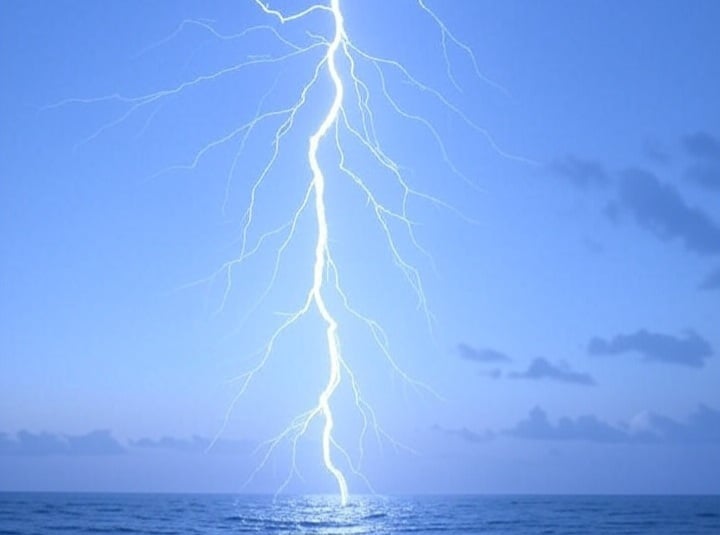 An illustration of blue sky lightning striking the ocean.