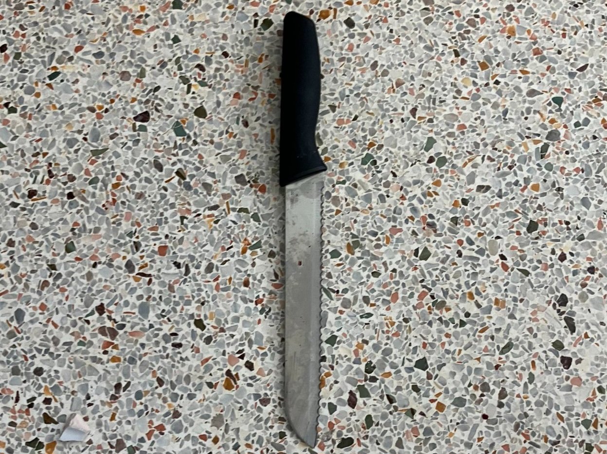 A knife on a terrazzo floor.