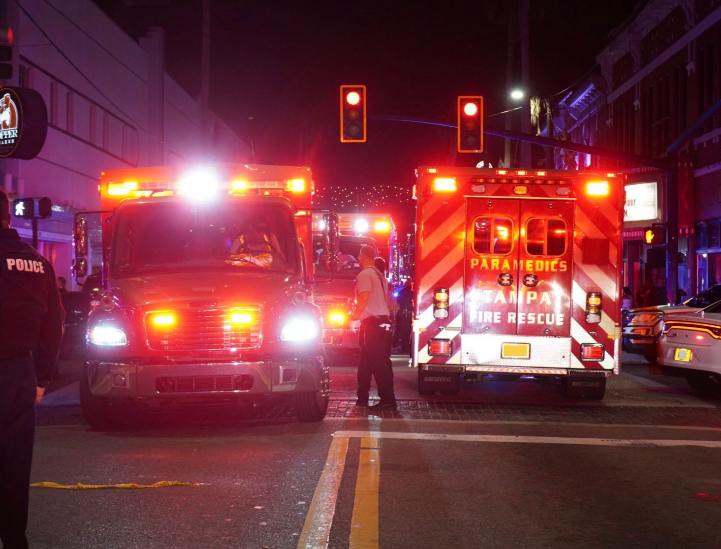 Photos from the scene showed ambulances, police vehicles, and first responders securing the area around a beige SUV involved in the crash, with holiday lights illuminating the historic surroundings.
